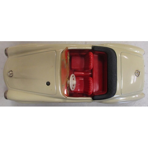 223 - Schuco. Tinplate clockwork self steer Mercedes 190SL No 2095, cream body, red interior, good plus in... 