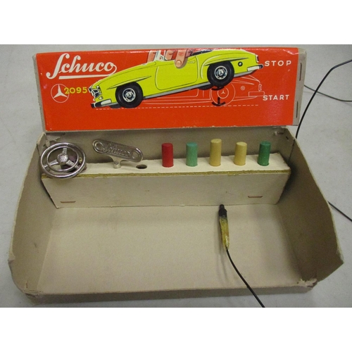 223 - Schuco. Tinplate clockwork self steer Mercedes 190SL No 2095, cream body, red interior, good plus in... 