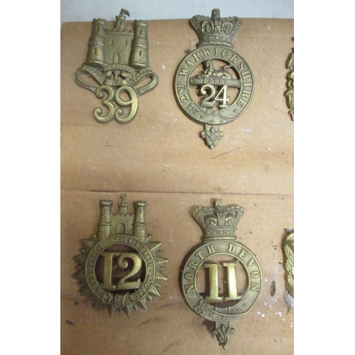 61 - 1874-81 Glengarry badge collection mounted on cardboard with 11th, 12th, 53rd, 59th, 105th, 40th etc... 