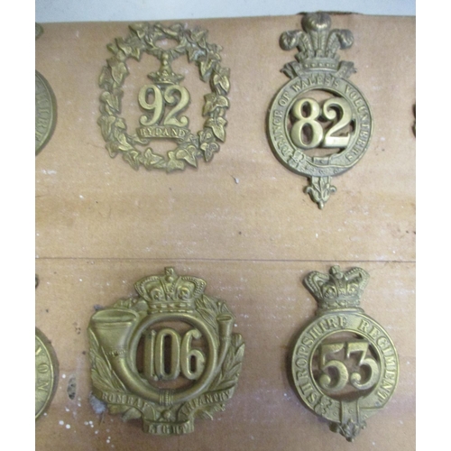 61 - 1874-81 Glengarry badge collection mounted on cardboard with 11th, 12th, 53rd, 59th, 105th, 40th etc... 