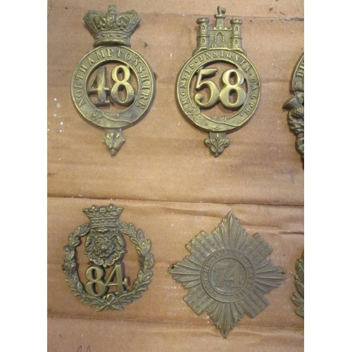 61 - 1874-81 Glengarry badge collection mounted on cardboard with 11th, 12th, 53rd, 59th, 105th, 40th etc... 