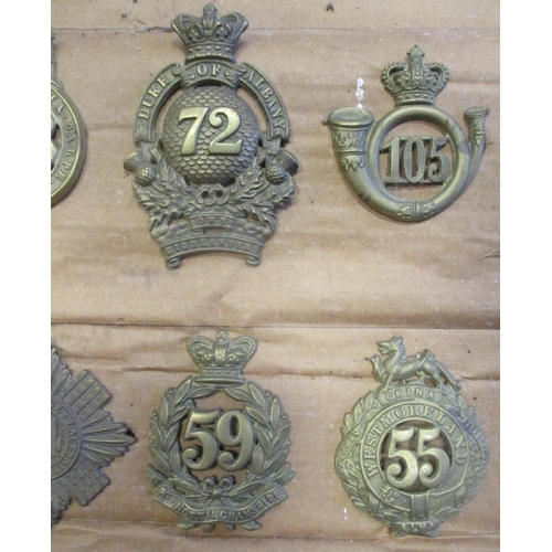 61 - 1874-81 Glengarry badge collection mounted on cardboard with 11th, 12th, 53rd, 59th, 105th, 40th etc... 