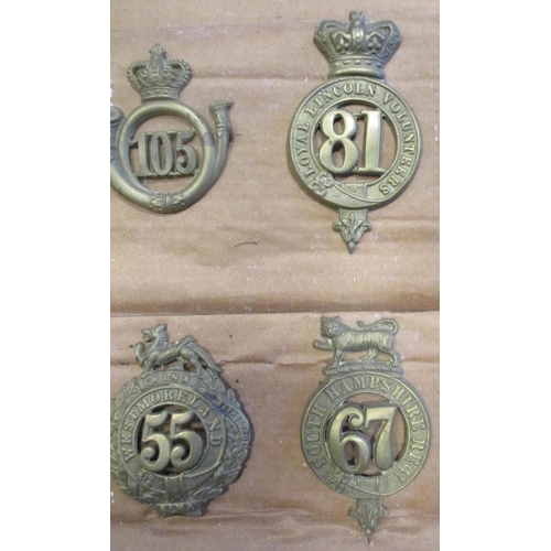 61 - 1874-81 Glengarry badge collection mounted on cardboard with 11th, 12th, 53rd, 59th, 105th, 40th etc... 