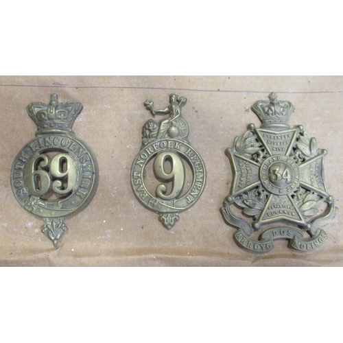 64 - 1874-81 Glengarry badge collection mounted on cardboard with 17th, 75th, 51st, 69th, 5th, 6th etc , ... 