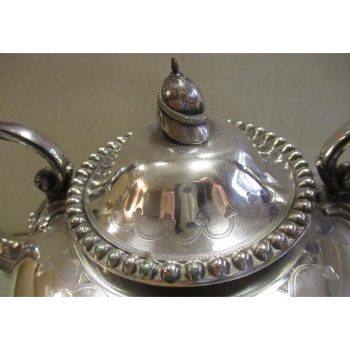 69 - 1878 silver presentation tea kettle, 25cm tall, lid fitted with cloth helmet replica piece, neatly e... 