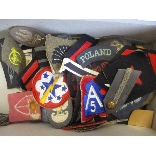 240 - Shoe box full of world cloth badges including rank, unit flashes, shoulder titles, arm bands etc in ... 