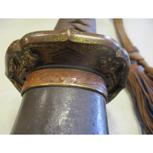 111 - WW2 era Japanese Army officer's shin-gunto and metal scabbard, with brown and blue tassels attached,... 