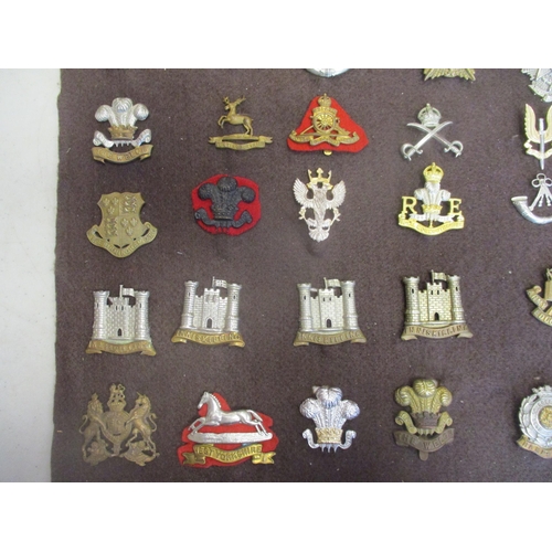 134 - Collection of metal cap badges mounted on a board within a glass frame including Para Regt (3), Bord... 