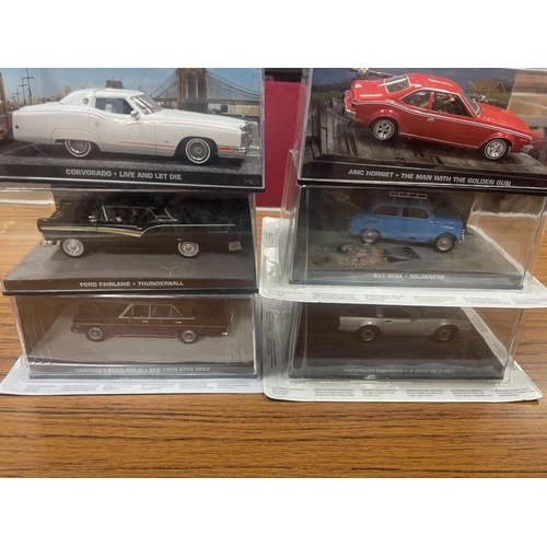 428 - Collection of James Bon 007 models in display cases with Corovorado Live and let die, Ford Fairlane ... 