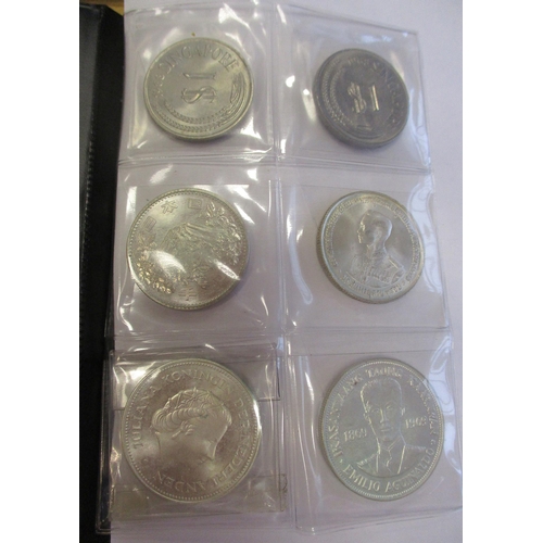 506 - World range in small Schulz coin album, some silver, including China Junk dollar, Maria Theresa thal... 