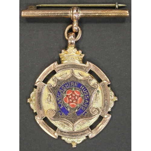 111 - 1910 Lancashire Hussars 9ct gold and enamel medal weighing 17.98g engraved 