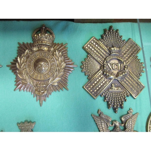 103 - Collection of cap badges with odd arm badge etc mounted on foam board in large wooden frame (91cm x ... 