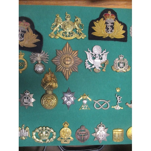 104 - Collection mounted on 2 boards of mostly cap badges, also few arm badges etc including QV Connaught ... 