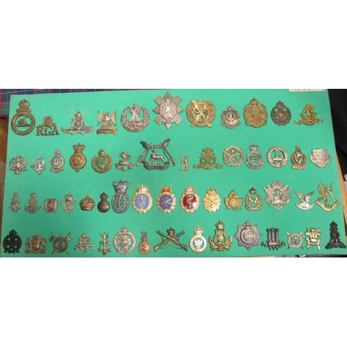 106 - Collection mounted on 3 boards of mostly cap badges, also few arm badges etc including QV 24th Foot,... 