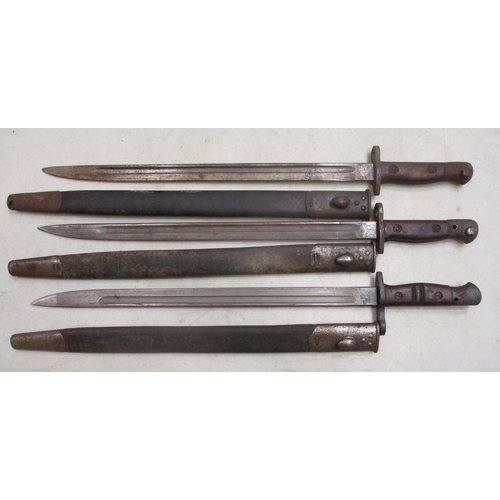 85 - British bayonet and scabbard range with:
1-2. Socket bayonets, only 1 with scabbard.
3. 1915 Sanders... 