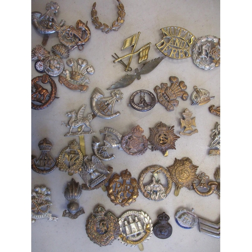 118 - Mixed collection, mainly metal cap badges, shoulder titles, sweetheart badges, trade badge, odd Germ... 