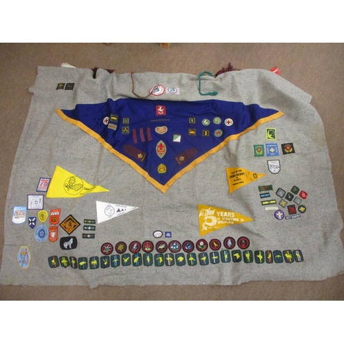 147 - Scout collection including large blanket poncho with wide range of badges, pennants and belt sewn on... 