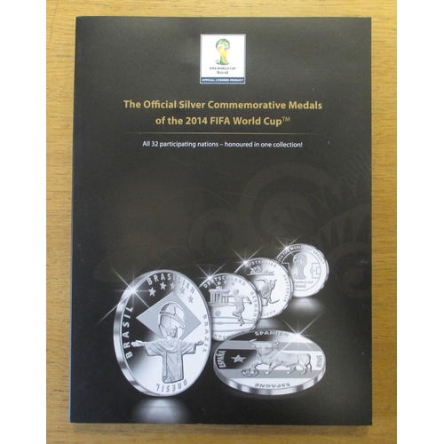 693 - 2014 FIFA World Cup silver 'proof-like' commemorative medal set in MDM folder. Qty 32 (½B)