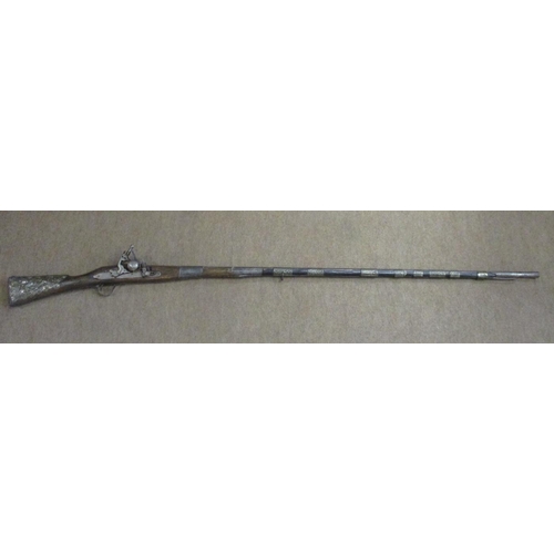 104 - Mixed range with possibly Ottoman style miquelet flintlock rifle, 10 crude metal bands to barrel, br... 