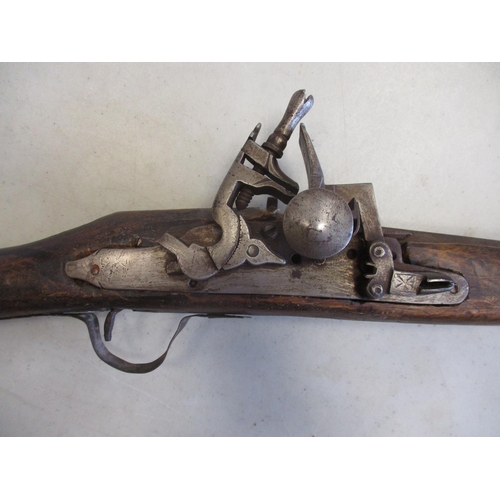 104 - Mixed range with possibly Ottoman style miquelet flintlock rifle, 10 crude metal bands to barrel, br... 