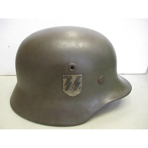 131 - Waffen SS M40 helmet, double decals, Q64 to left side, rear marking erased, with leather liner and c... 