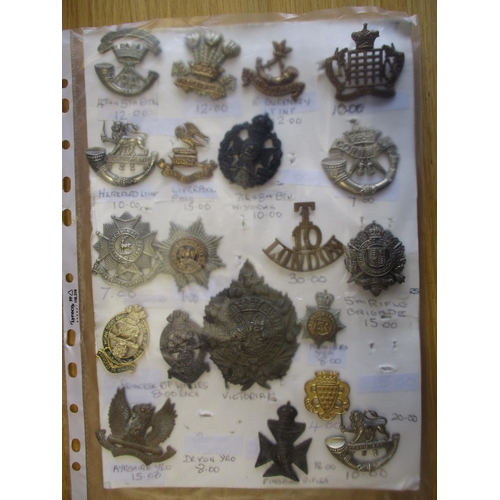 134 - Collection of mainly metal cap badges mounted on cards, wide range of regiments including HLI, Yorsh... 