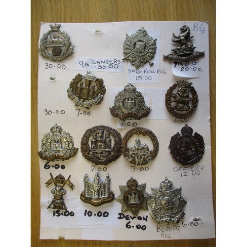 140 - Collection of metal mainly cap badges mounted on cards, wide range of regiments including Malta Mili... 