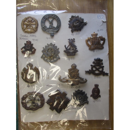 140 - Collection of metal mainly cap badges mounted on cards, wide range of regiments including Malta Mili... 