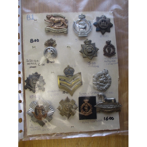 140 - Collection of metal mainly cap badges mounted on cards, wide range of regiments including Malta Mili... 