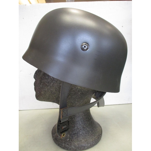 148 - Collection with original WW2 era US helmet with net, British helmet with net, German Army leather be... 