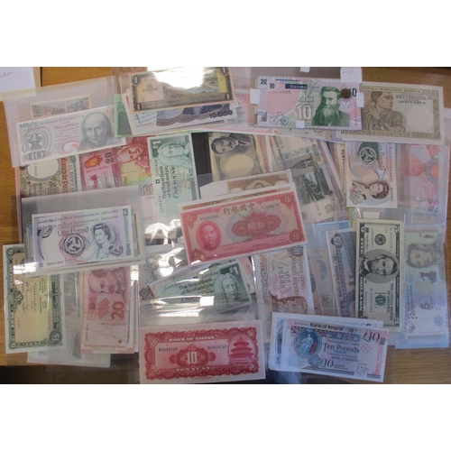 238 - Accumulation of world banknotes in plastic wallets, generally extremely fine to near uncirculated, i... 