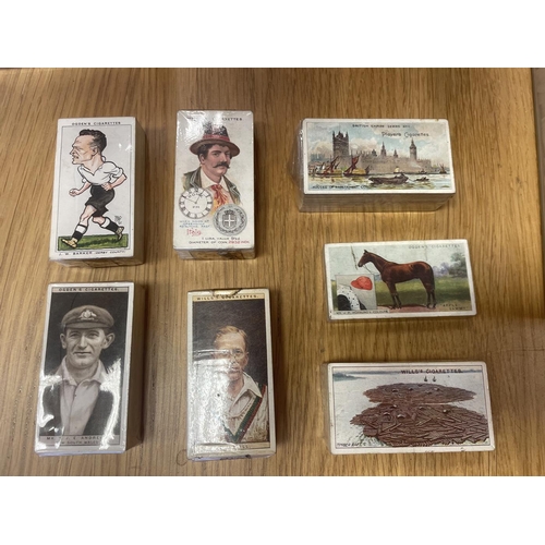 10 - Collection in sealed cigarette card clear packs with sets including Ogdens Cricket 1926, Derby Entra... 