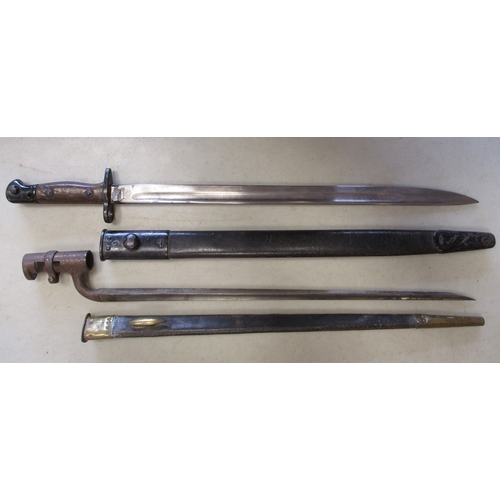 135 - Pair of bayonets with:
1. Socket bayonet with leather scabbard.
2. 1907 Pattern by Wilkinson, variou... 