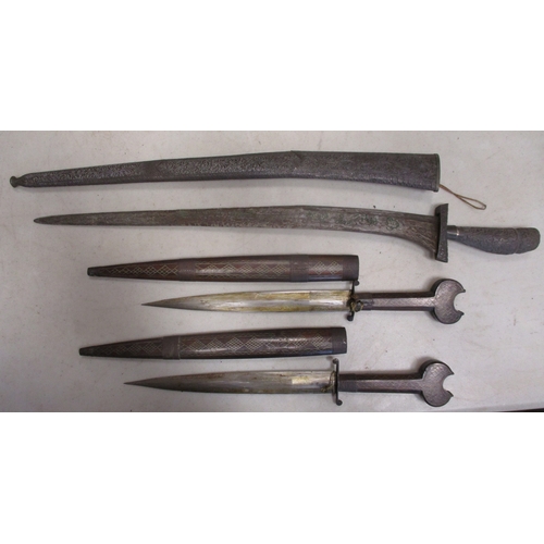 123 - Mainly Asian edged weapon range all with scabbards with Malaysian kris, pair of daggers with wooden ... 