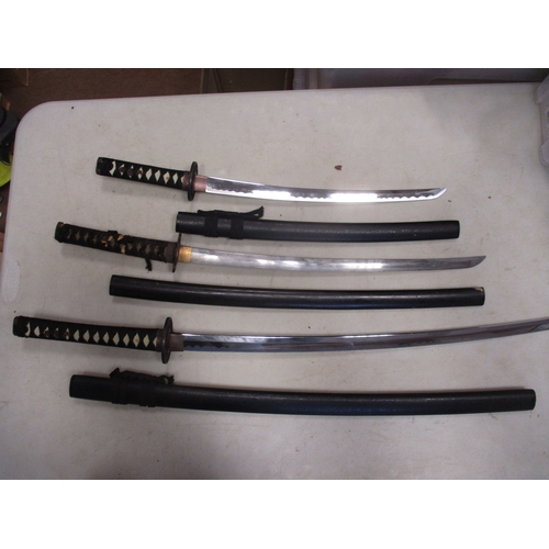 123 - Mainly Asian edged weapon range all with scabbards with Malaysian kris, pair of daggers with wooden ... 