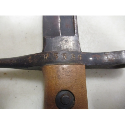 140 - Italian M1891 bayonet and leather scabbard, crossguard stamped PS1942 and R5536, good very fine. WIL... 