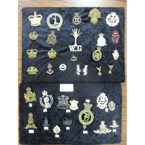 160 - Range of cap badges, shoulder titles, buttons etc mounted on boards, strength in Leicester Regt & Ye... 