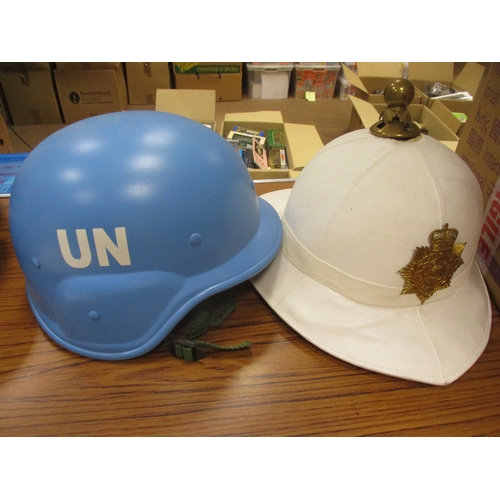 162 - Uniform collection with various dress caps (4), UN helmet, pith helmet, Sgt Agnew's RAF uniforms inc... 