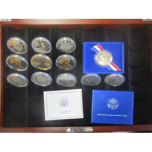 983 - USA. Range of silver $1 in display case, with proof 1986 Ellis Island, 1989 Congress and 1990 Eisenh... 