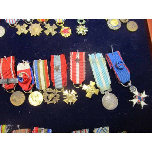 130 - France. Miniature medal collection, 9 are enamelled, in presentation glass topped tray including Med... 