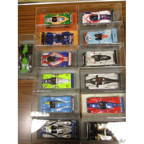 238 - Collection of race cars plinthed in display cases generally mint in mint boxes. Qty 25 (B)