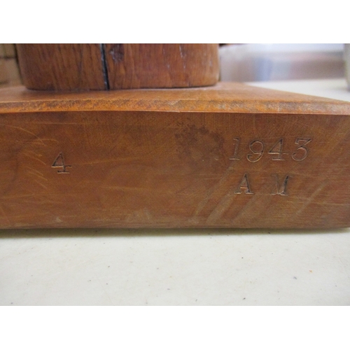 174 - Rare 1943 Air Ministry wooden flying helmet modelling head mounted on square wooden block, the head ... 