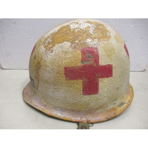 180 - WW2 U.S. Medic casualty's M-1 helmet and liner, shell with white textured paint with large Red Cross... 