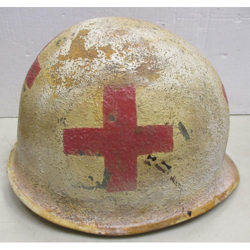 180 - WW2 U.S. Medic casualty's M-1 helmet and liner, shell with white textured paint with large Red Cross... 