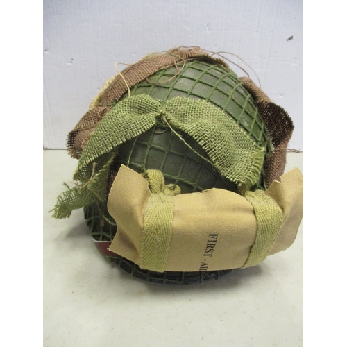 183 - U.S. Paratrooper's M-1 helmet and liner, green textured painted shell, A strap with leather chincup,... 