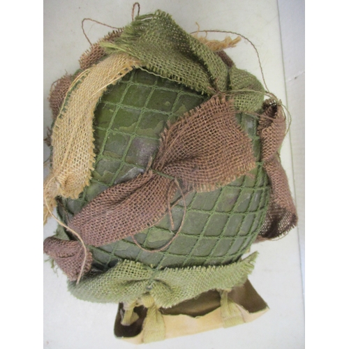 183 - U.S. Paratrooper's M-1 helmet and liner, green textured painted shell, A strap with leather chincup,... 