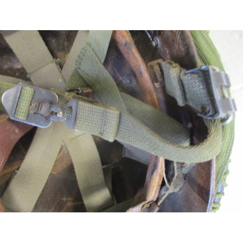 183 - U.S. Paratrooper's M-1 helmet and liner, green textured painted shell, A strap with leather chincup,... 