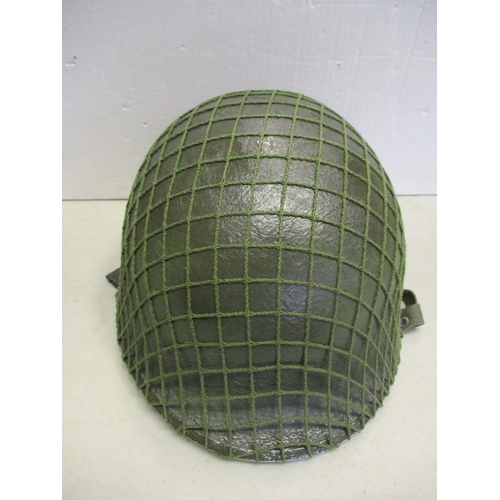 185 - U.S. Paratrooper's M-1 helmet and liner, green textured painted shell, webbing A strap with webbing ... 