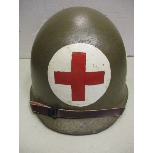 193 - WW2 U.S. Medic's M-1 helmet and liner, shell with khaki paint with large Red Cross on white circles ... 