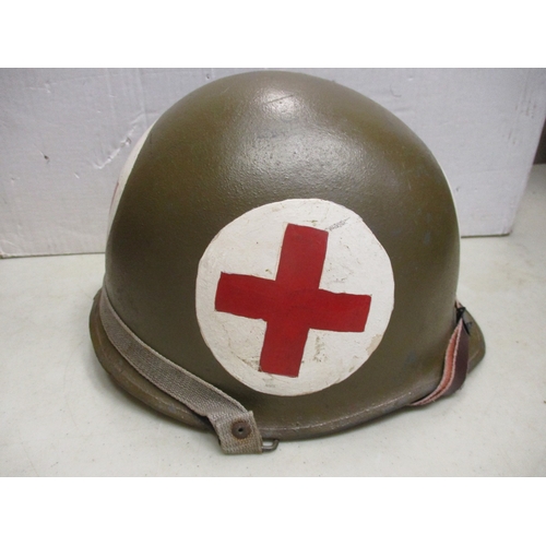 193 - WW2 U.S. Medic's M-1 helmet and liner, shell with khaki paint with large Red Cross on white circles ... 